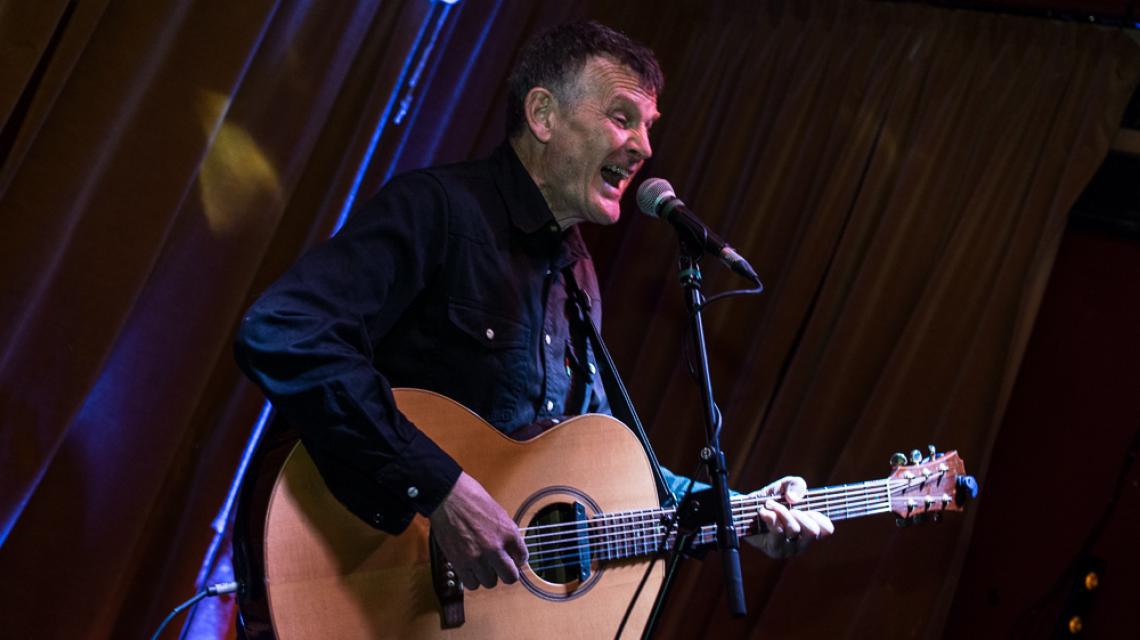 James Bisset singing on stage at Gullivers NQ